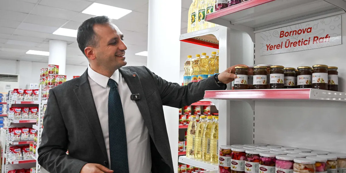 Koyu gri takım elbiseli ve kravatlı bir erkek, bir market reyonunda üzerinde 